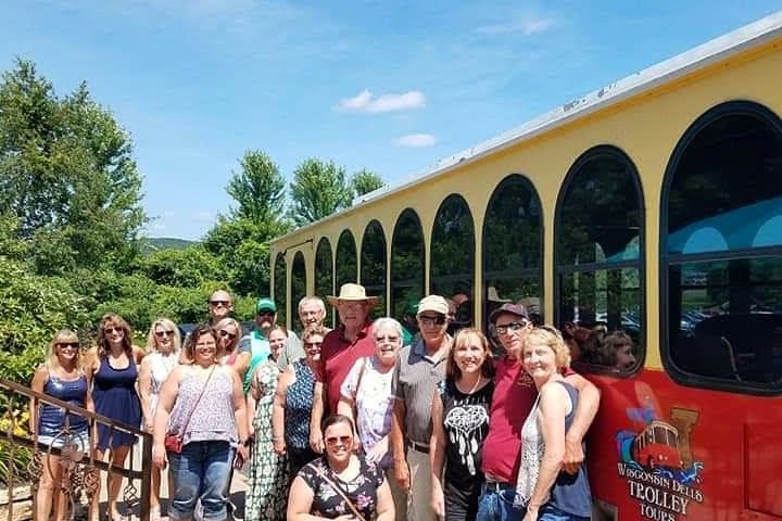 a group of people standing in front of a bus