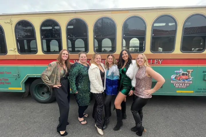 a group of people standing in front of a bus